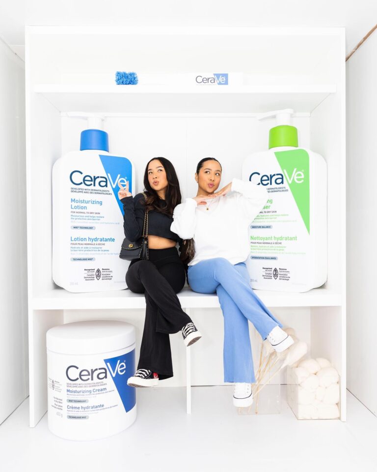 Two guests pose inside a giant CeraVe shelf display at CeraVe House, Stackt Market, Toronto